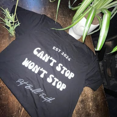 Black T-shirt with bold “Can’t Stop Won’t Stop” and “Pit Bull Faith EST 2024” design, unisex Christian tee.